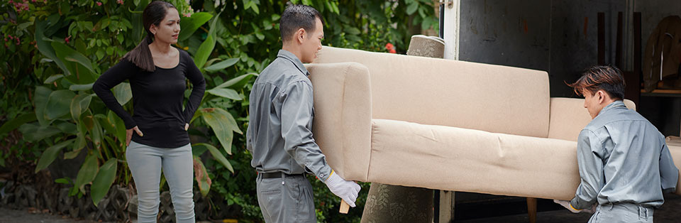 Movers loading couch van